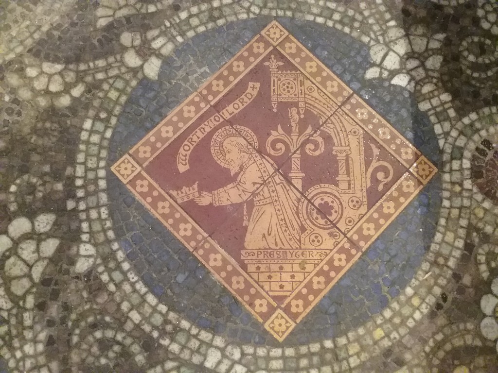 An encaustic tile depicting an angel, wet in mosaic floor
